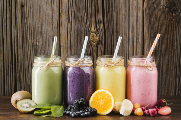colorful-fruit-smoothies-composition-wooden-background